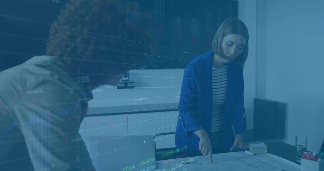 Architects Reviewing Blueprints with Overlay Charts in Modern Office