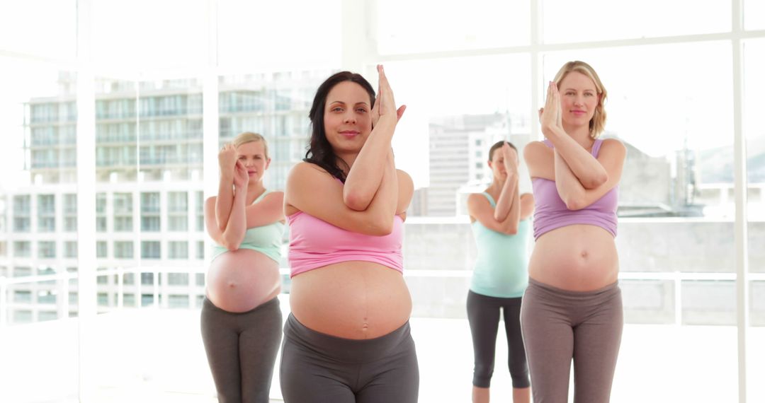 Pregnant Women Practicing Yoga in Bright Studio - Free Images, Stock Photos and Pictures on Pikwizard.com