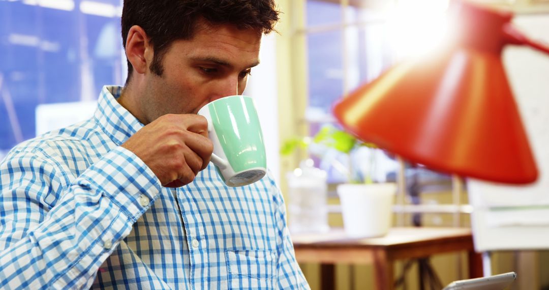 Young Professional Man Drinking Coffee During Work at Office - Free Images, Stock Photos and Pictures on Pikwizard.com