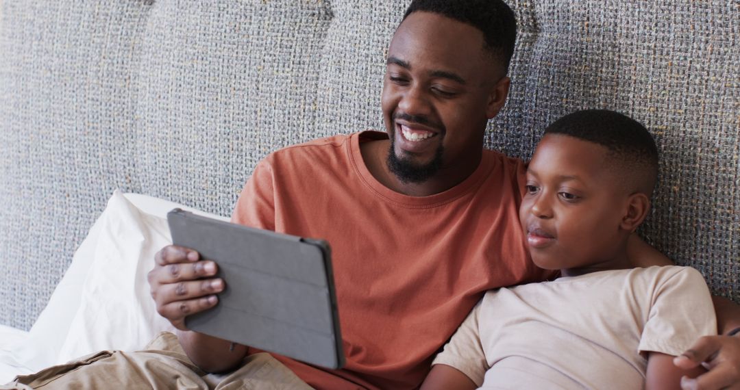 Father and Son Enjoying Time Together Using Tablet