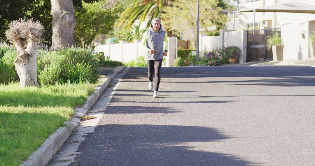 Elderly Woman Jogging on Suburban Street Sin Bright Morning - Free Images, Stock Photos and Pictures on Pikwizard.com