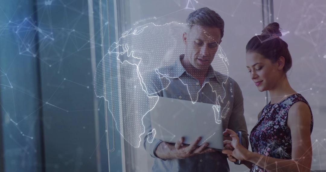 Professionals collaborating over laptop with holographic globe and network visualization