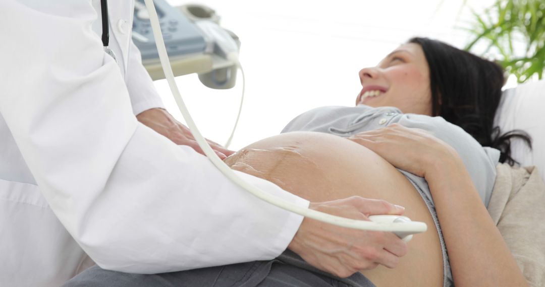 Pregnant Woman Receiving Ultrasound Examination with Doctor's Care - Free Images, Stock Photos and Pictures on Pikwizard.com