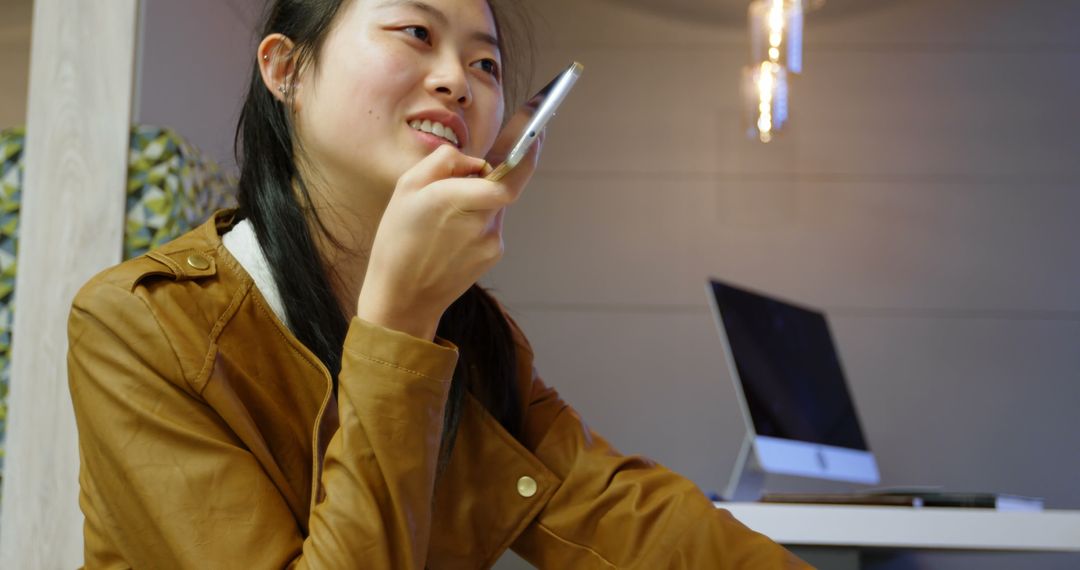 Female Executive Communicating via Smartphone in Modern Office