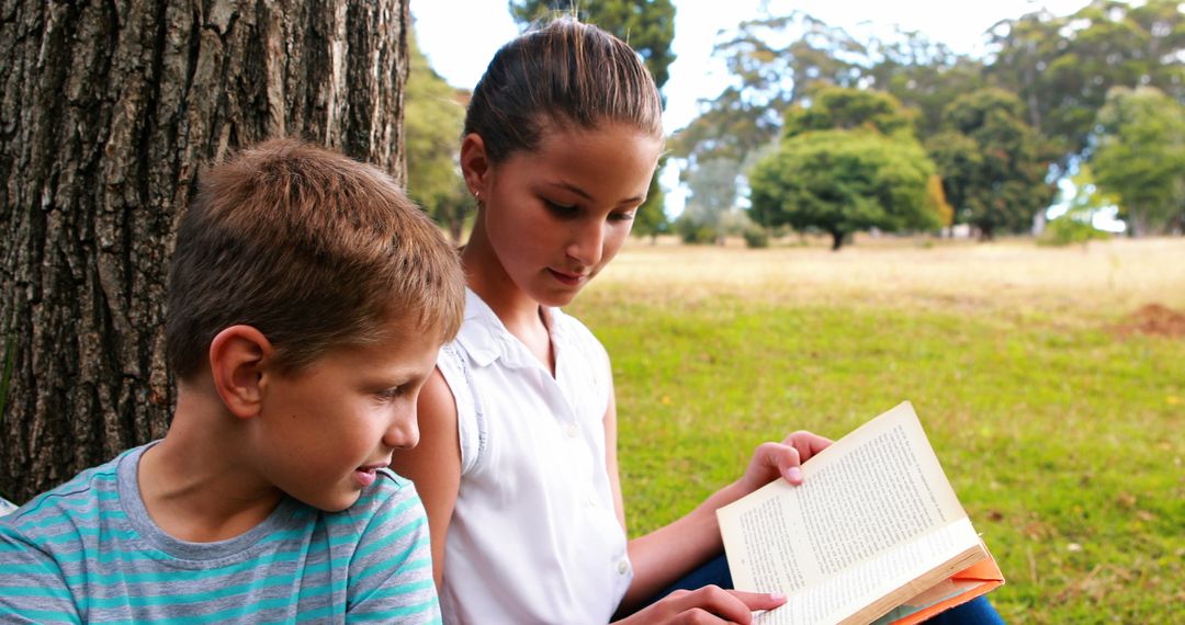 Kids Reading Under Tree in Park - Free Images, Stock Photos and Pictures on Pikwizard.com