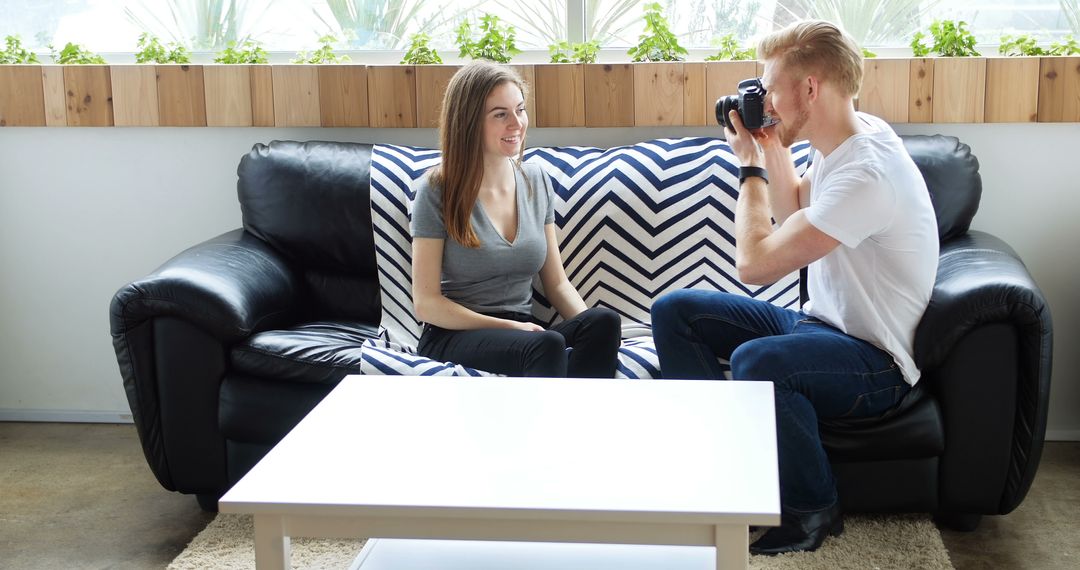 Man Taking Pictures of Smiling Woman on Couch at Home - Free Images, Stock Photos and Pictures on Pikwizard.com