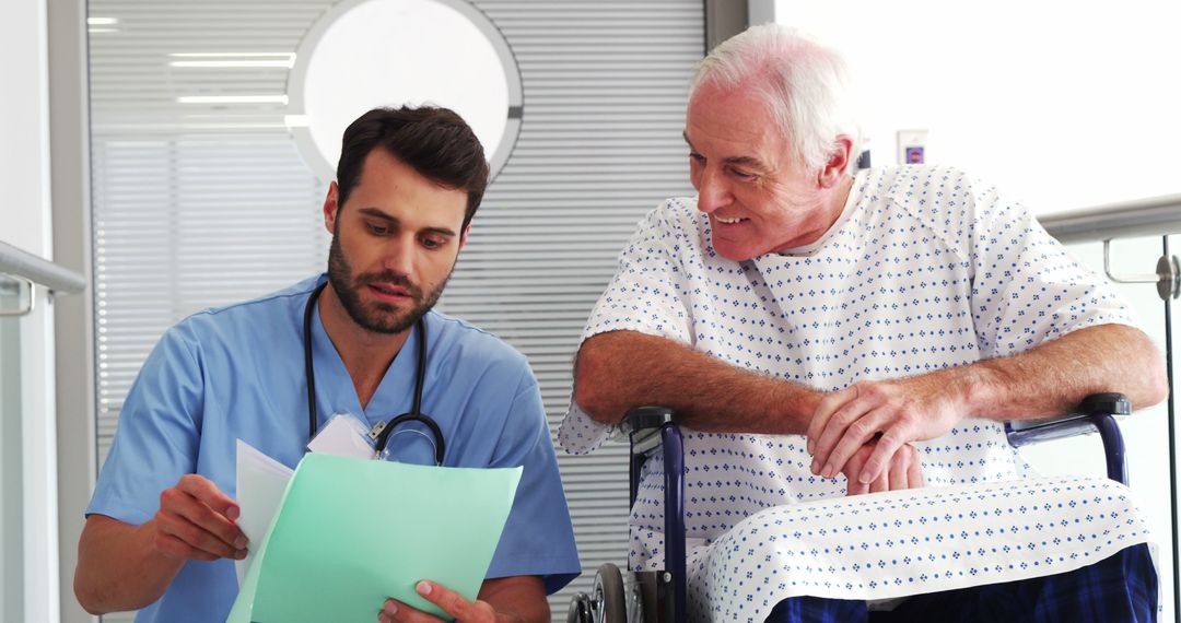 Nurse Discussing Medical Records with Elderly Patient in Wheelchair - Free Images, Stock Photos and Pictures on Pikwizard.com