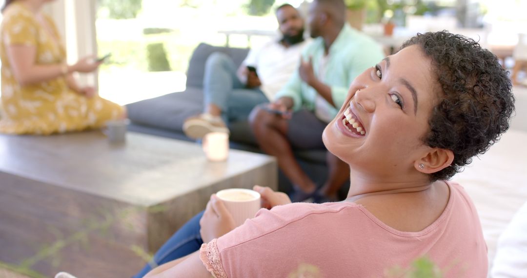 Smiling Woman Enjoying Coffee with Friends in Relaxing Atmosphere