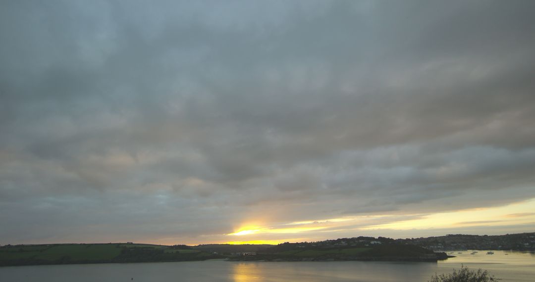 Beautiful Sunset Over Serene Lake with Cloudy Sky - Free Images, Stock Photos and Pictures on Pikwizard.com