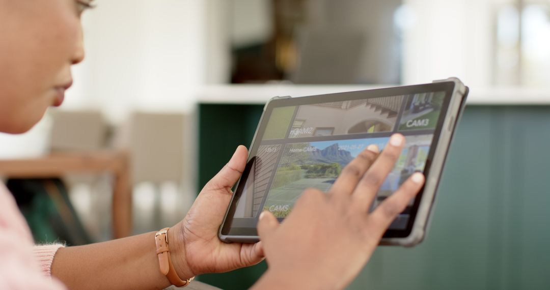 Woman Monitoring Home Security on Tablet Computer at Home
