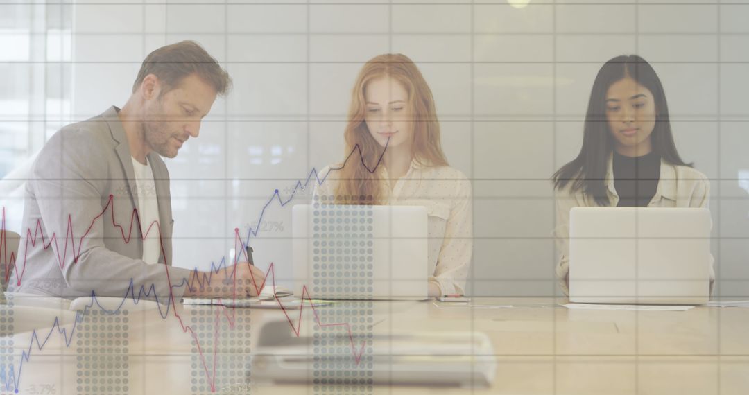 Business Team Analyzing Financial Data Using Laptops in Office