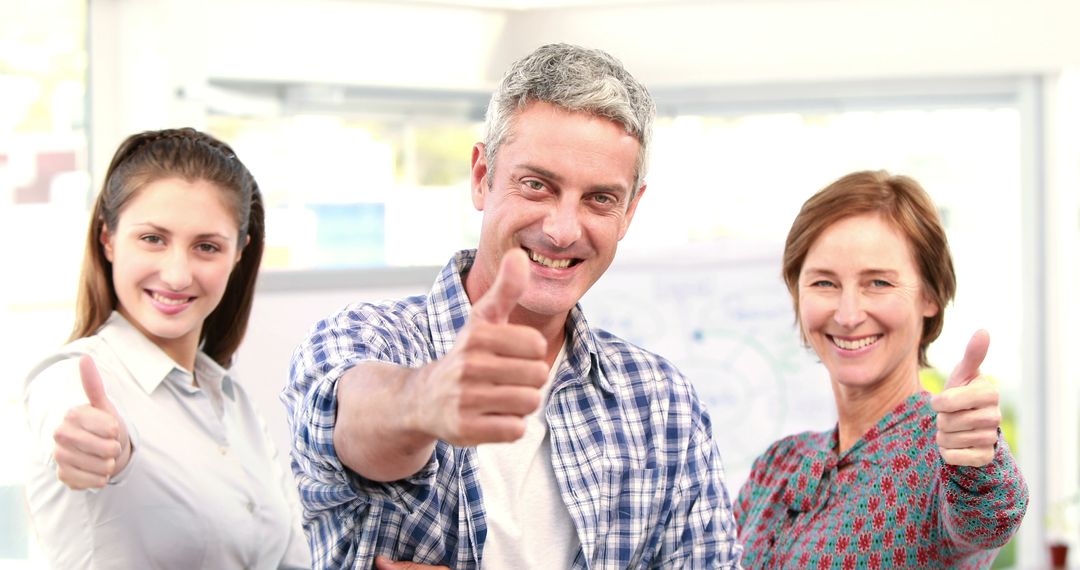 Happy Team Giving Thumbs Up in Office Environment - Free Images, Stock Photos and Pictures on Pikwizard.com