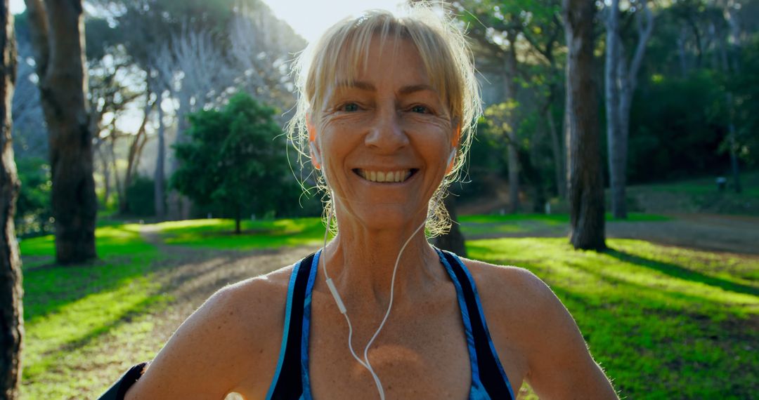 Senior woman smiling while jogging in park at sunrise - Free Images, Stock Photos and Pictures on Pikwizard.com