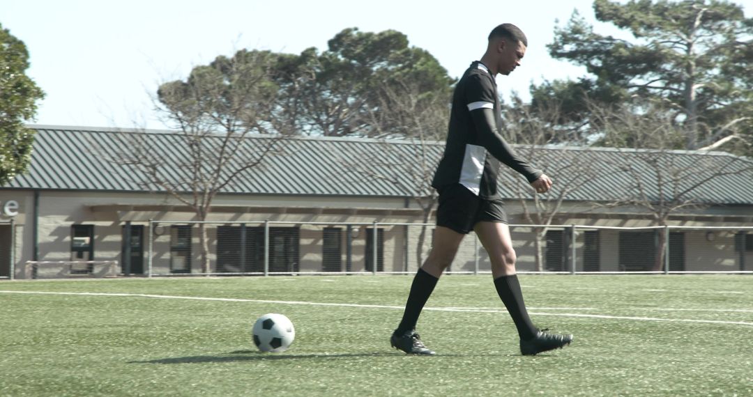 Focused Soccer Player Preparing for Practice on Sunny Day
