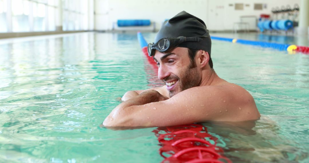 Male Swimmer Relaxing on Pool Lane Line Smiling - Free Images, Stock Photos and Pictures on Pikwizard.com