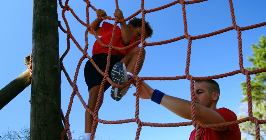 Child Climbing Rope Course with Instructor Assistance - Free Images, Stock Photos and Pictures on Pikwizard.com