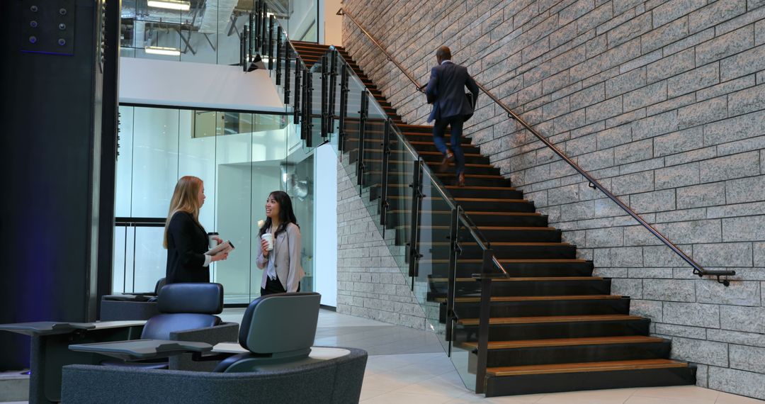 Modern Office Lobby with Business People and Stairs - Free Images, Stock Photos and Pictures on Pikwizard.com