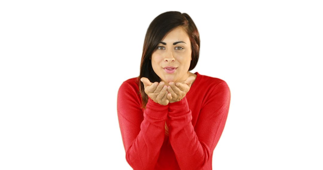 Woman Blowing Kiss Wearing Red Sweater Against White Background - Free Images, Stock Photos and Pictures on Pikwizard.com