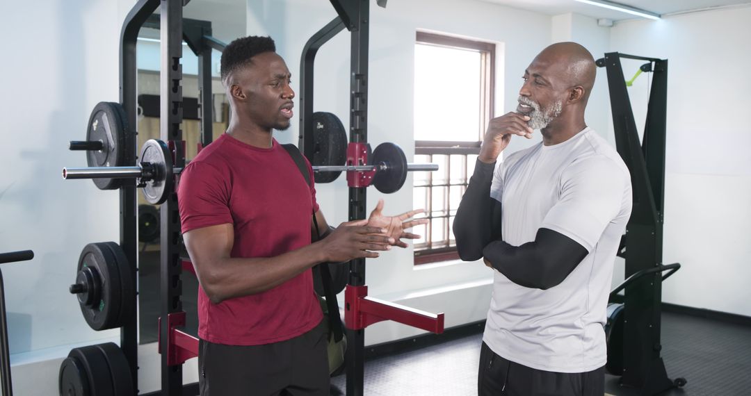 African American Men Discussing Workout Form at Gym