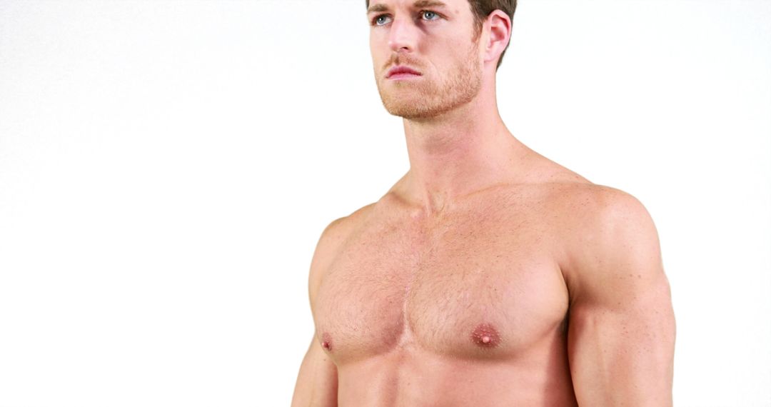 A shirtless Caucasian young man appears focused and serious, with copy space - Free Images, Stock Photos and Pictures on Pikwizard.com