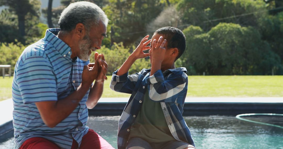 Grandfather and Grandson Playing by the Poolside Outdoors - Free Images, Stock Photos and Pictures on Pikwizard.com