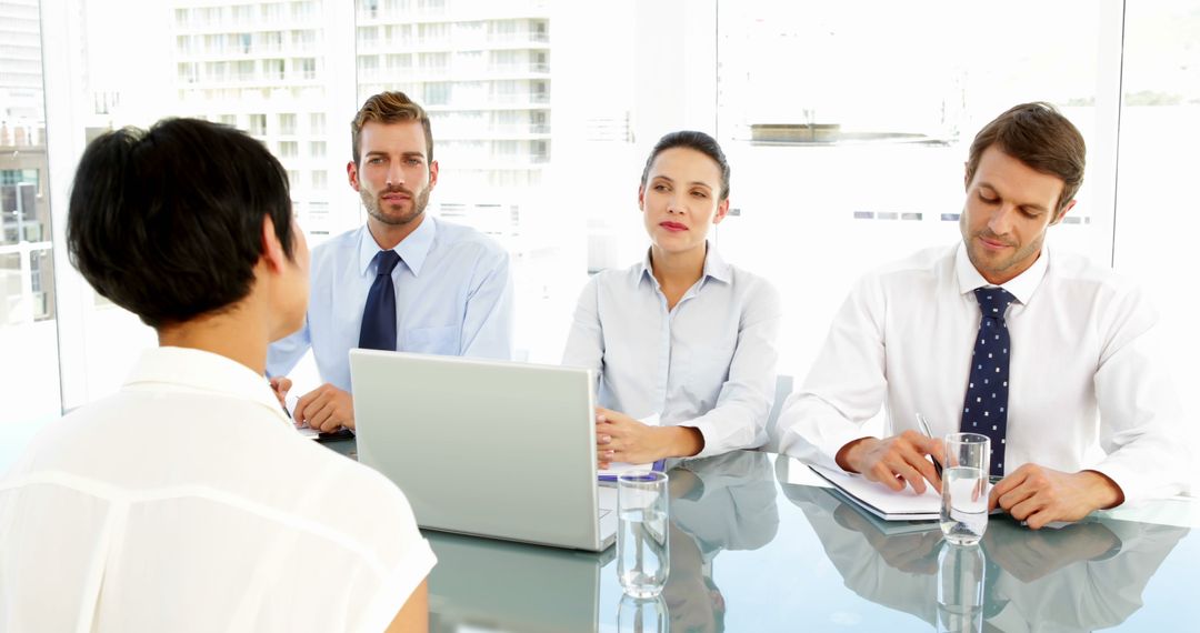 Interview Panel Meeting with Job Applicant in Modern Office