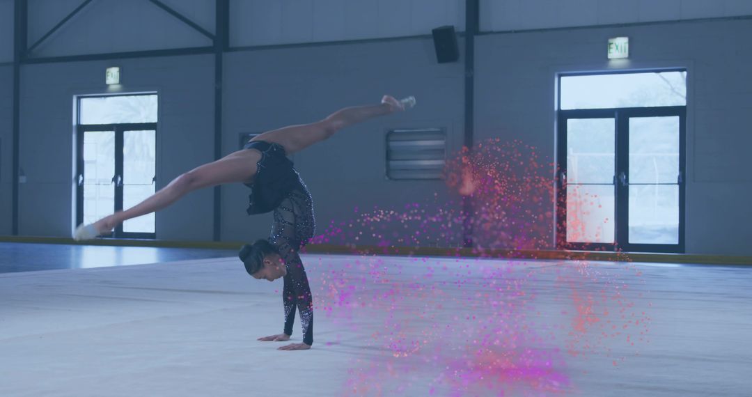 Gymnast Performing One-Arm Handstand Split with Artistic Flair in Gym
