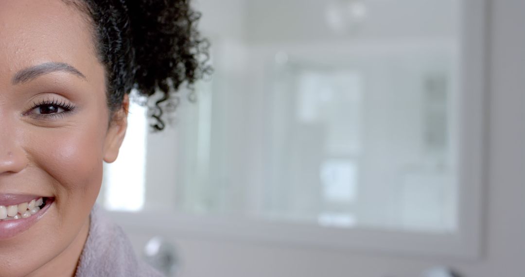 Smiling Woman with Curly Hair in Bright Modern Bathroom - Free Images, Stock Photos and Pictures on Pikwizard.com