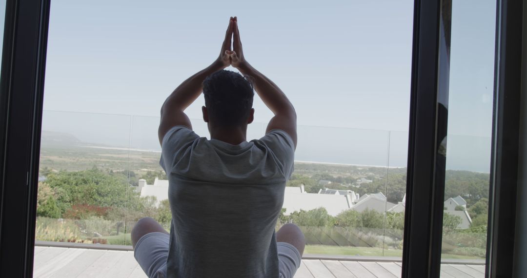 Man Practicing Yoga Meditation on Balcony with Scenic View - Free Images, Stock Photos and Pictures on Pikwizard.com