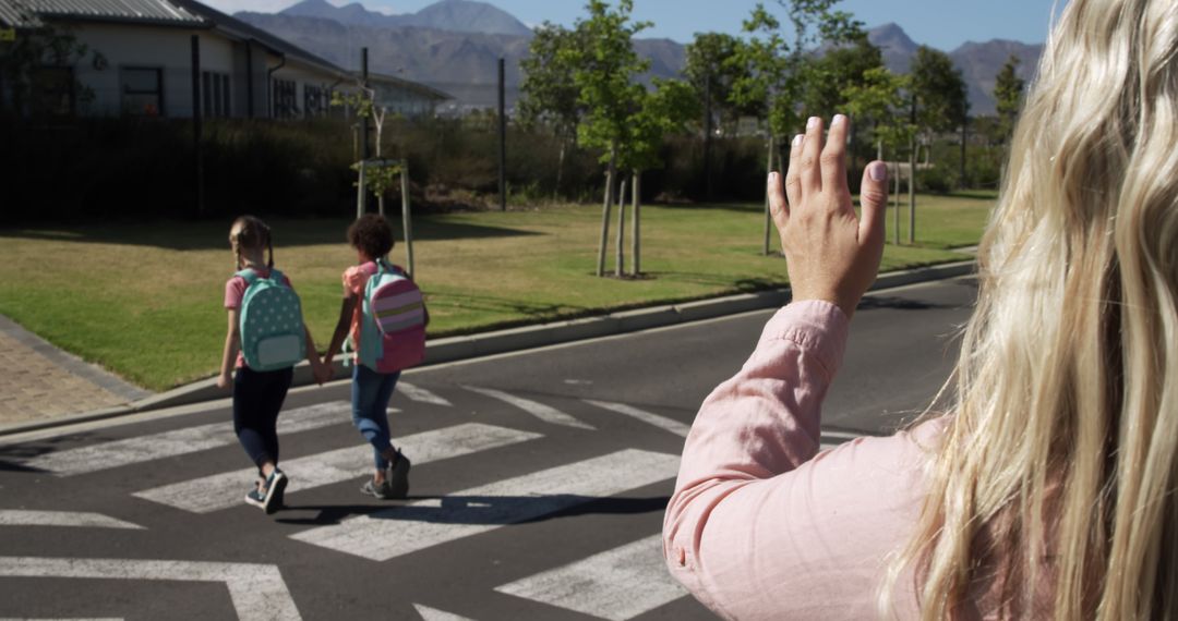 Parent Waving Goodbye to Kids Walking to School on Crosswalk - Free Images, Stock Photos and Pictures on Pikwizard.com