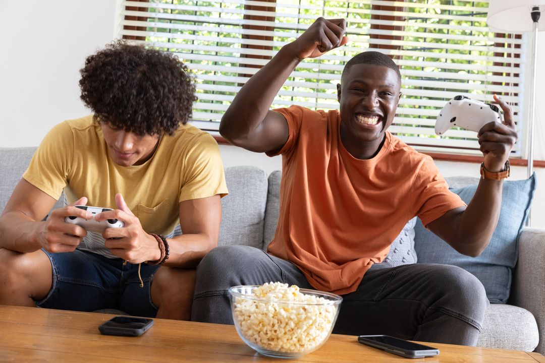 Two Friends Enjoying Video Games on Comfortable Couch