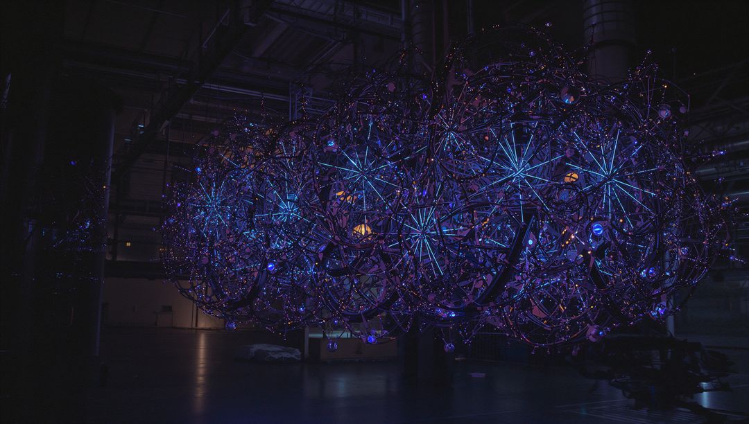 Futuristic Luminous Spherical Art Installation in Industrial Space