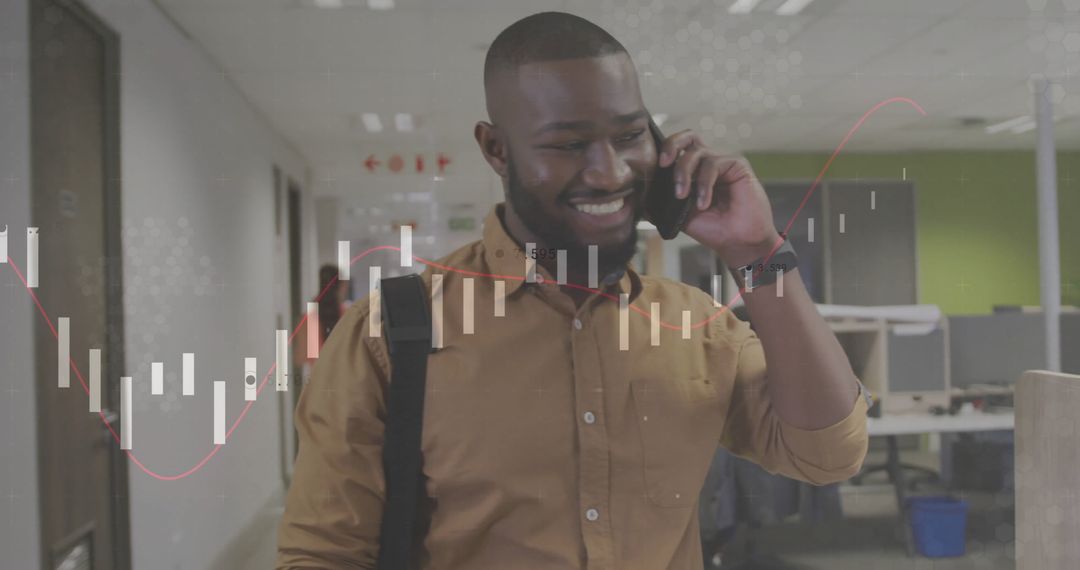 Professional Man Walking Through Office While on Phone Call