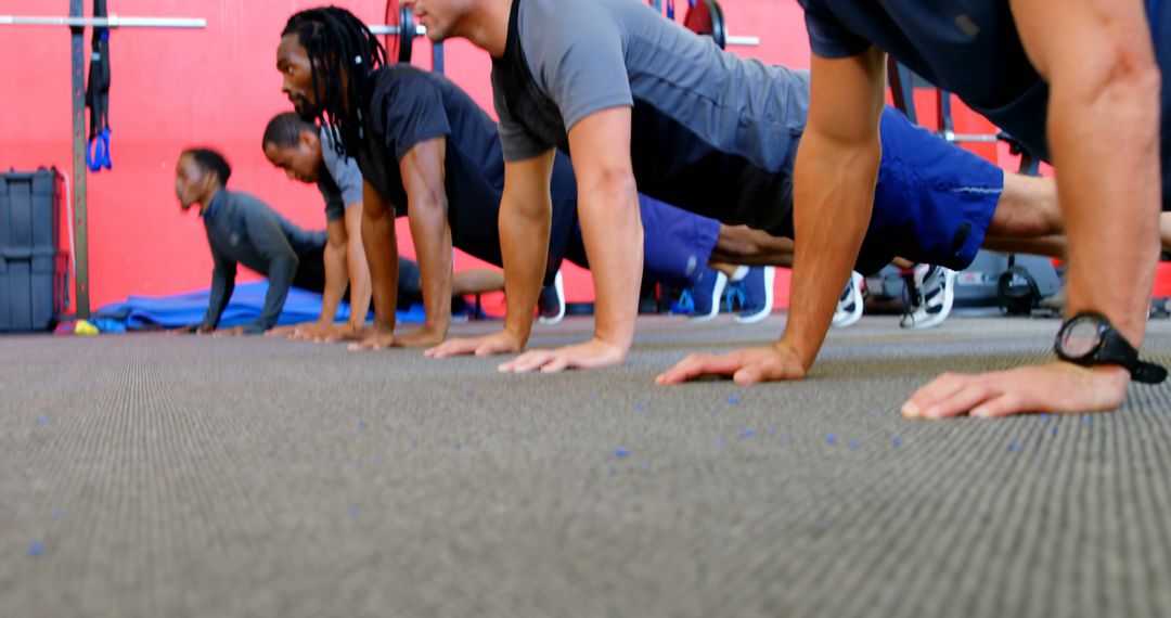 Diverse Football Team Doing Push-Ups in Gym - Free Images, Stock Photos and Pictures on Pikwizard.com