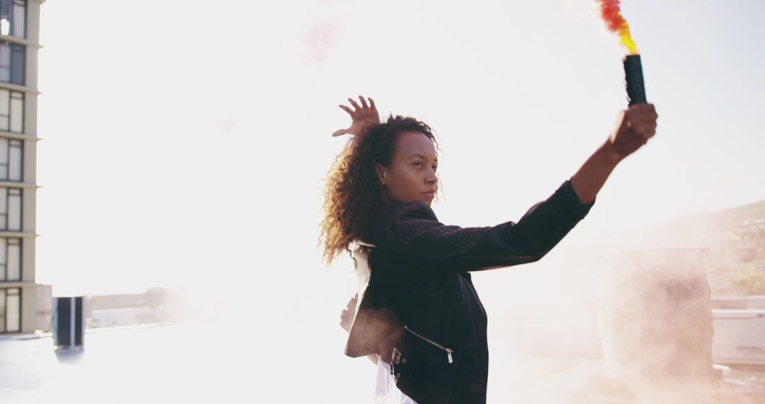 Woman Holding Smoke Bomb on Rooftop in Bright Sunlight - Free Images, Stock Photos and Pictures on Pikwizard.com