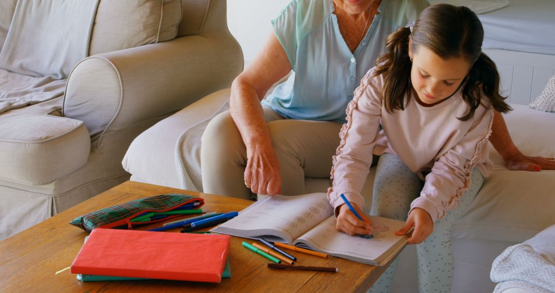 Grandmother Helping Girl with Homework at Home - Free Images, Stock Photos and Pictures on Pikwizard.com