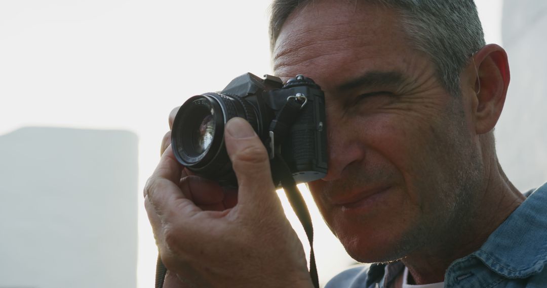 Man Taking Photo with Vintage Camera Outdoors