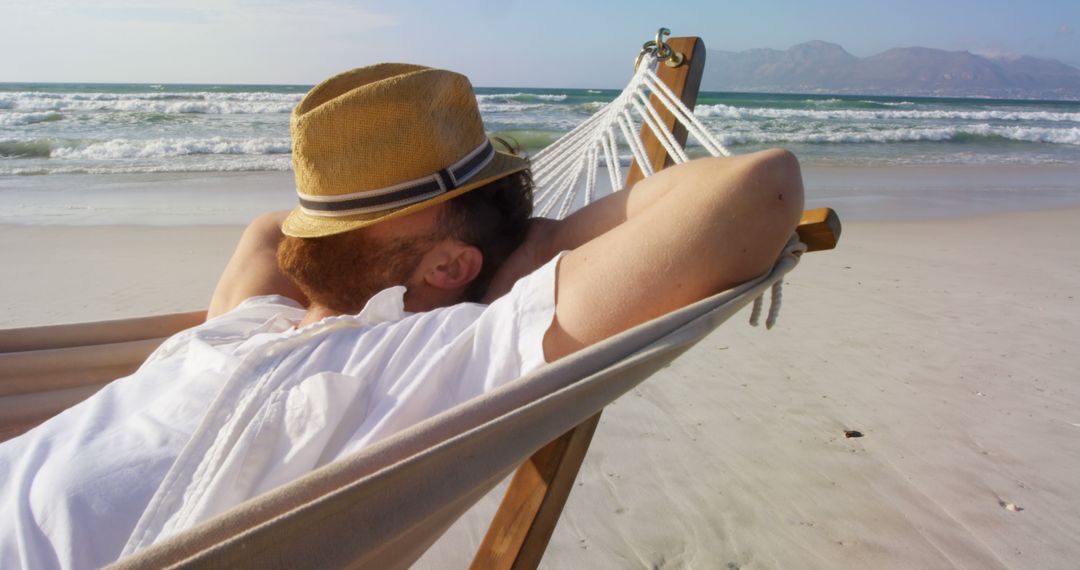 Man Relaxing in Hammock on Beach with Ocean View - Free Images, Stock Photos and Pictures on Pikwizard.com