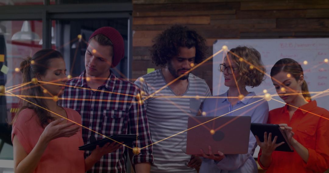 Team Collaborating on Digital Network in Modern Office