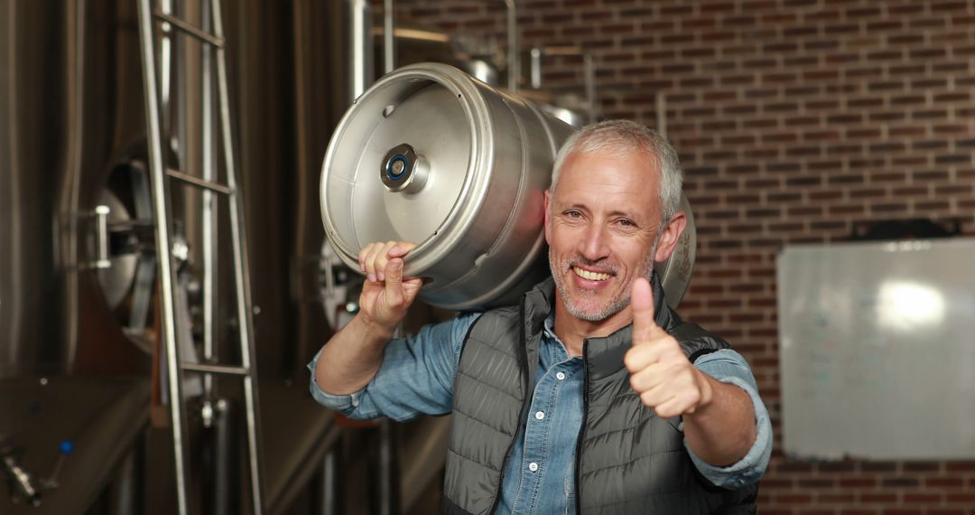 Happy Brewery Worker Carrying Keg Showing Thumbs Up - Free Images, Stock Photos and Pictures on Pikwizard.com