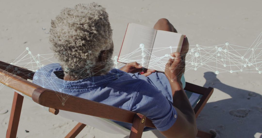 Elderly Man Enjoying Book and Digital Network at Beach