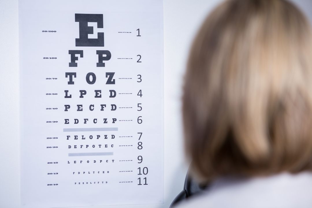 Optometrist Examining Eye Chart in Clinic - Free Images, Stock Photos and Pictures on Pikwizard.com