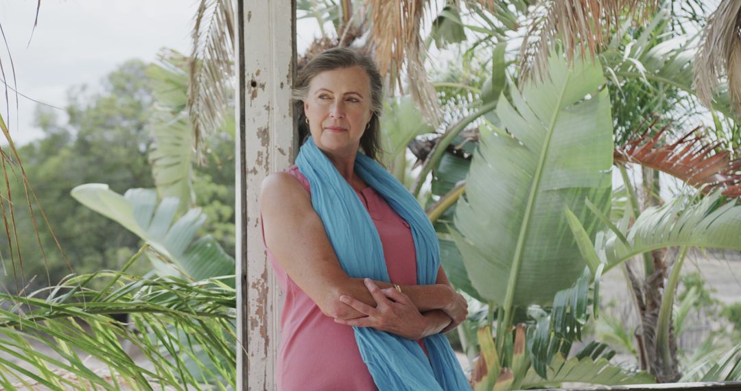 Happy senior caucasian woman leaning on pillar outside house on beach, copy space - Free Images, Stock Photos and Pictures on Pikwizard.com