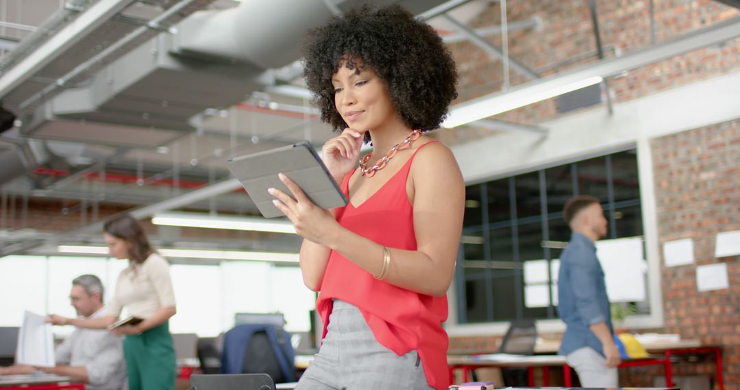 Professional African Woman Using Tablet in Creative Office Space