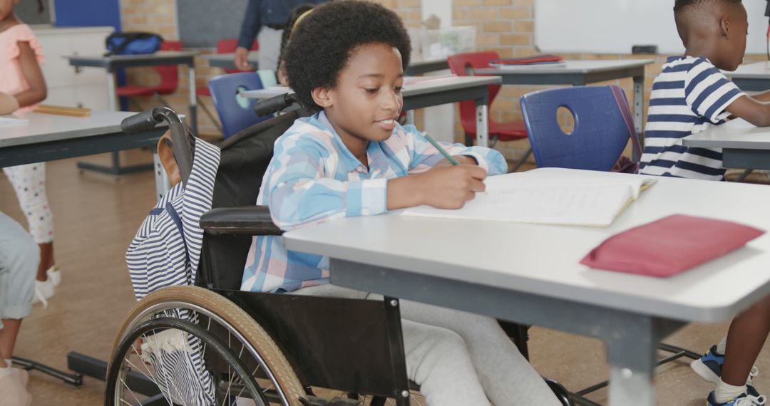 Student in wheelchair studying at desk in inclusive classroom - Free Images, Stock Photos and Pictures on Pikwizard.com