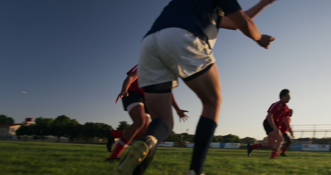 Rugby Players Competing in Intense Match Under Clear Sky - Free Images, Stock Photos and Pictures on Pikwizard.com