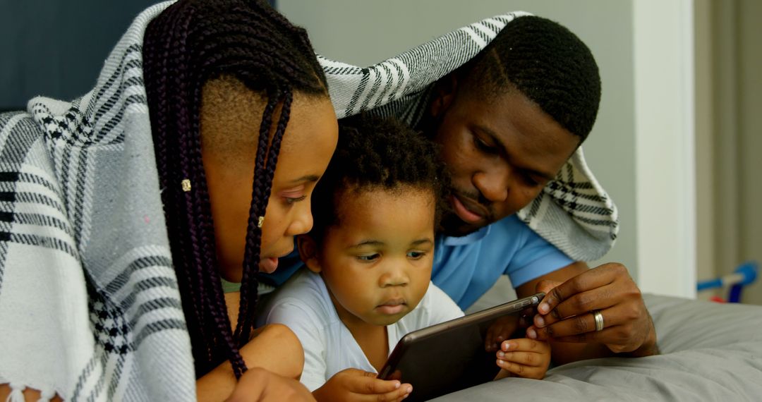 Family Using Tablet Together Under Blanket - Free Images, Stock Photos and Pictures on Pikwizard.com