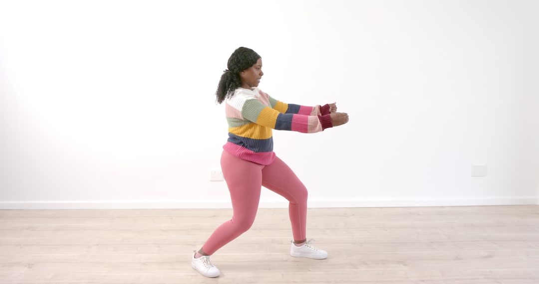 Woman Practicing Tai Chi in Colorful Attire Indoor Serenity