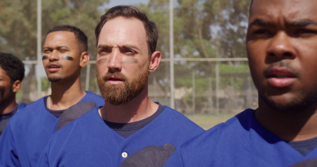 Diverse Baseball Team Standing on Field During Anthem