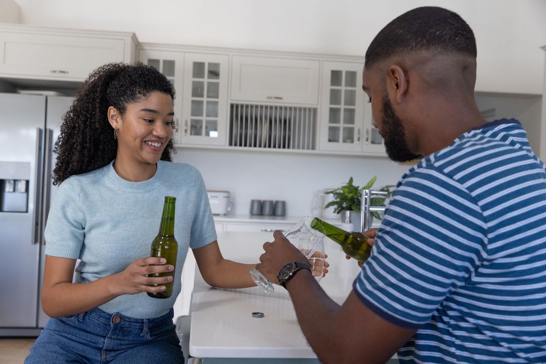 Couple Relaxing with Beer in Modern Kitchen Setting